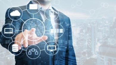 Businessman interacting with a digital network of cloud, database, and communication icons.