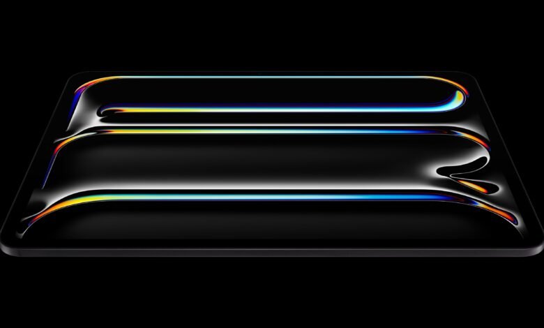 Sleek black tablet with colorful light reflections on its screen.