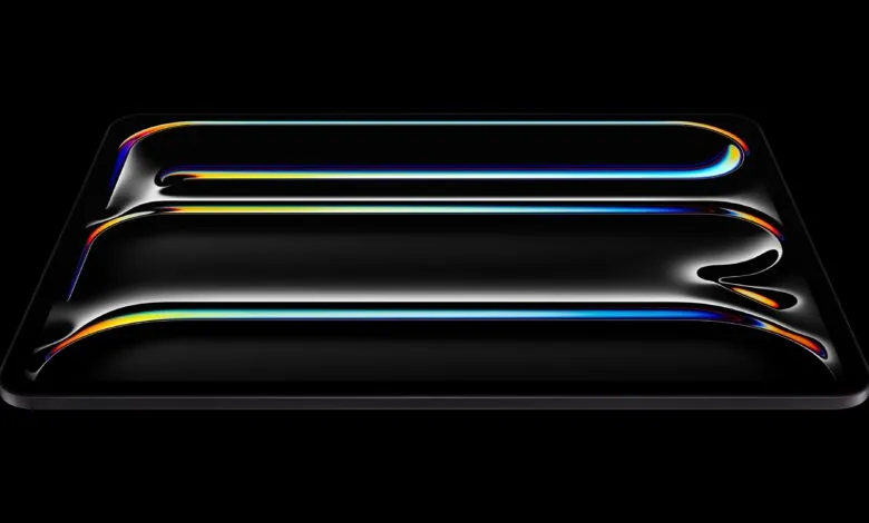 Sleek black tablet with colorful light reflections on its screen.