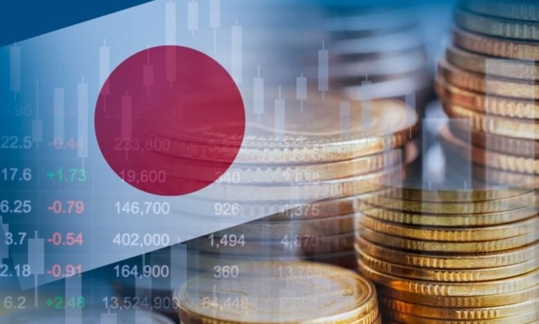 Stacks of gold coins overlaid with the Japanese flag and stock market charts.