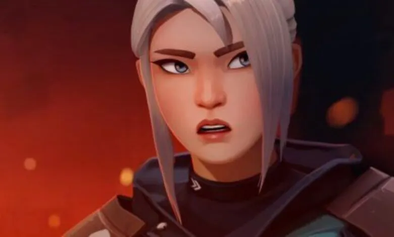 Close-up of Jett from Valorant with a determined expression, set against a fiery background.