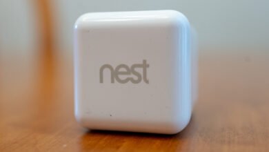 A white Nest device with the Nest logo prominently displayed.