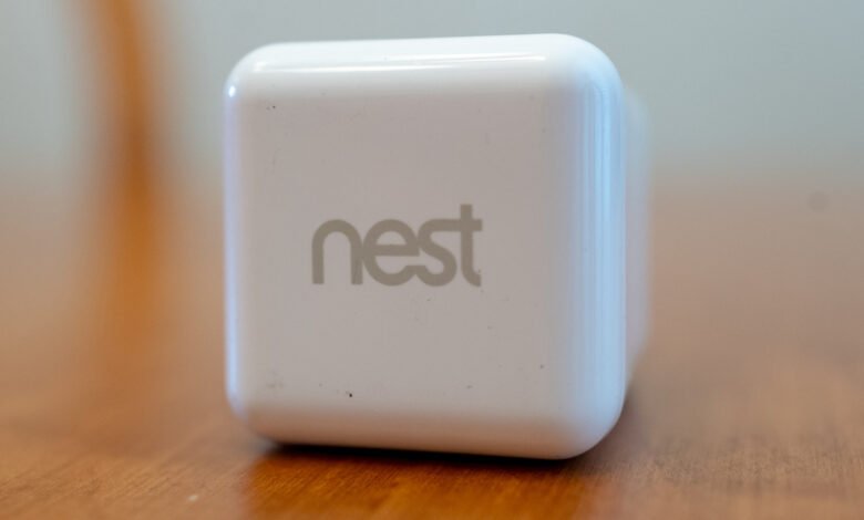 A white Nest device with the Nest logo prominently displayed.