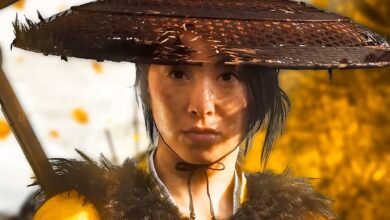 Close-up of a person wearing a conical straw hat and fur trim, looking forward.