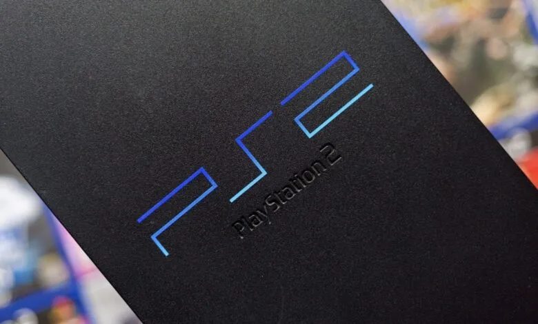 Close-up of the black PlayStation 2 console with its iconic blue logo.