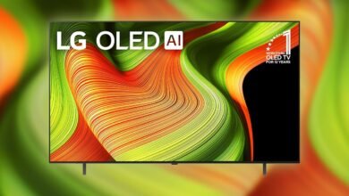 LG OLED AI TV displaying a vibrant, abstract wave pattern in red, orange, and green.
