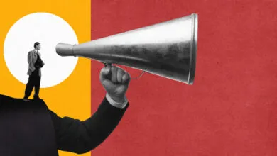 Man in suit standing on a shoulder holding a megaphone against a red and yellow background.