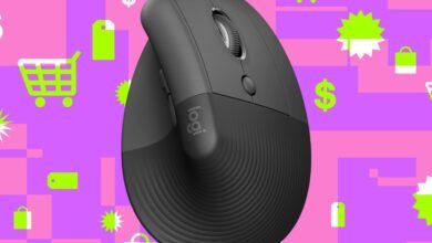 Close-up of a dark gray ergonomic Logitech mouse against a vibrant purple and pink background with shopping icons.