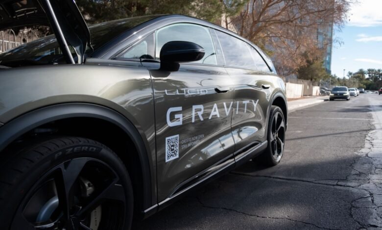 Side view of a Lucid Gravity electric SUV with its hood open.