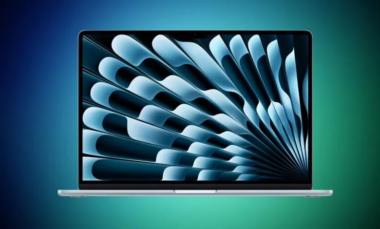 Silver MacBook Air laptop displaying a blue abstract wallpaper with flowing shapes.