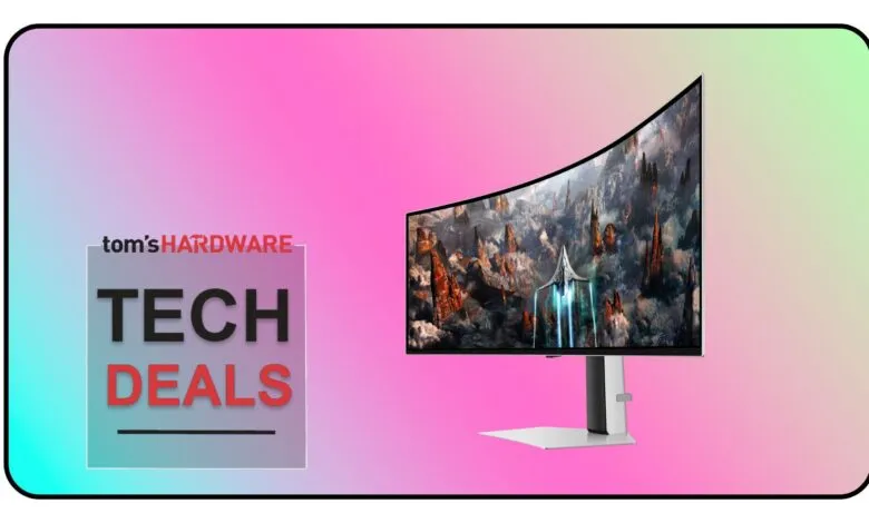 Curved monitor displaying a futuristic landscape with a spaceship, next to a 'Tom's Hardware Tech Deals' graphic.