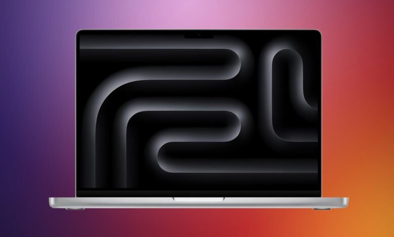 A sleek silver MacBook Pro displays a dark, abstract wallpaper with glowing curved lines.