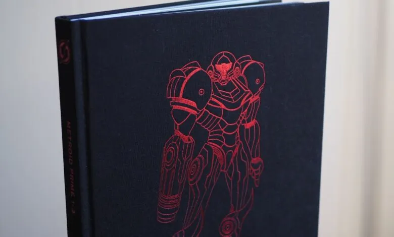 Dark blue book cover with a red outline of Samus Aran's power suit from Metroid Prime.