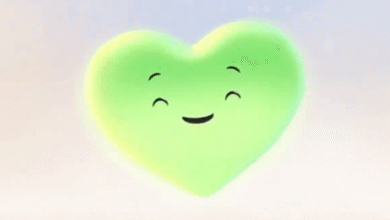 A glowing, smiling green heart character with closed eyes and a happy expression.