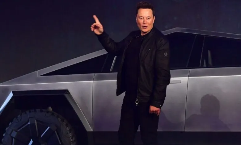 Elon Musk presenting the Tesla Cybertruck, a futuristic electric pickup truck.