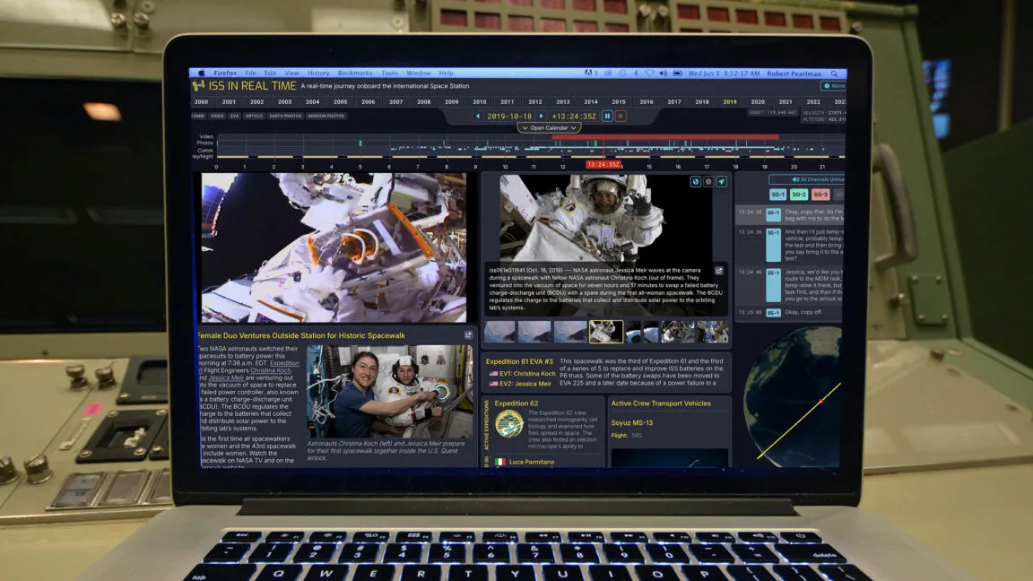 Laptop screen displaying ISS in Real Time software with astronaut images and mission data.