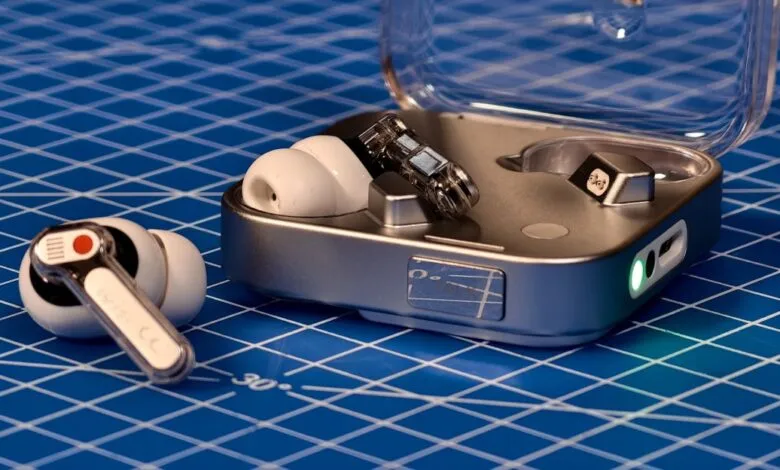 White wireless earbuds and charging case on a blue grid background