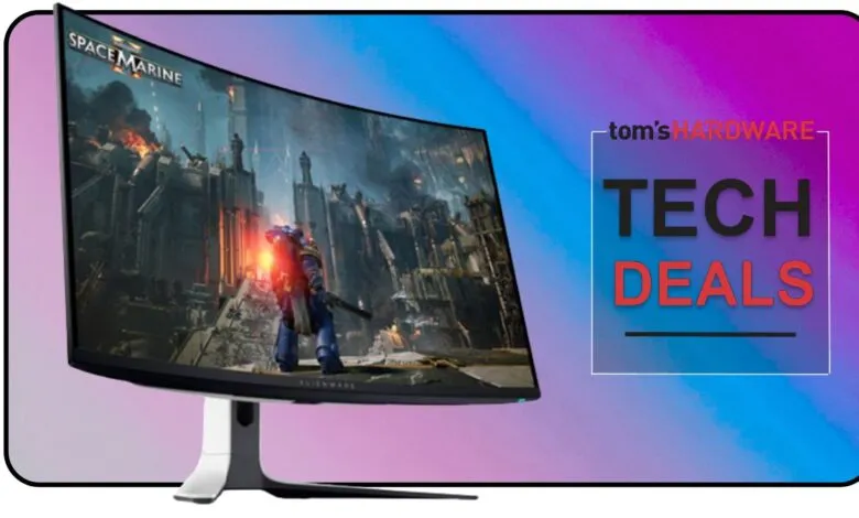 Curved gaming monitor displaying Space Marine game, with 'Tom's Hardware Tech Deals' overlay.