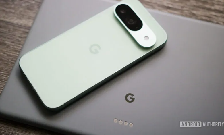 Close-up of a mint green Google Pixel phone resting on a gray Google Pixel tablet.