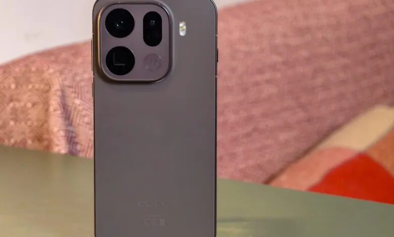 Close-up of the back of a dark gray Oppo Find X9 Pro smartphone with a prominent camera module.