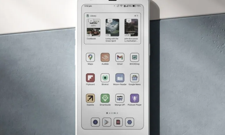 Close-up of a smartphone screen displaying a library of books and various app icons.