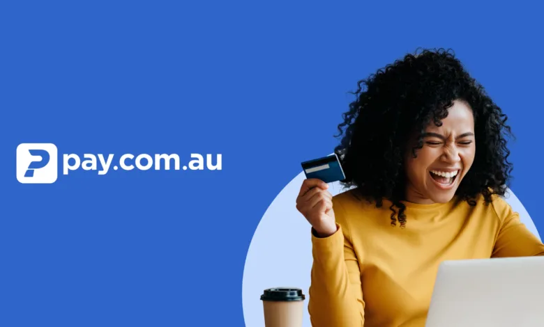 Woman celebrating while holding a credit card and looking at a laptop.