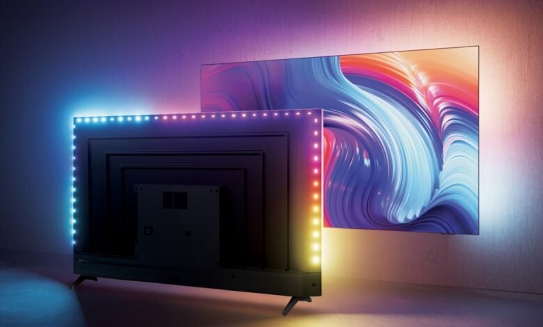 Two modern TVs displaying vibrant abstract art, one with colorful LED backlighting.