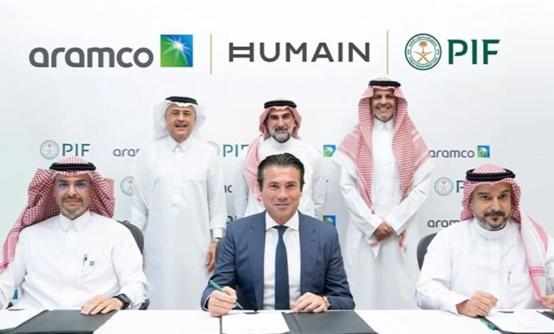 Five men in formal attire posing for a photo at a signing ceremony with company logos.