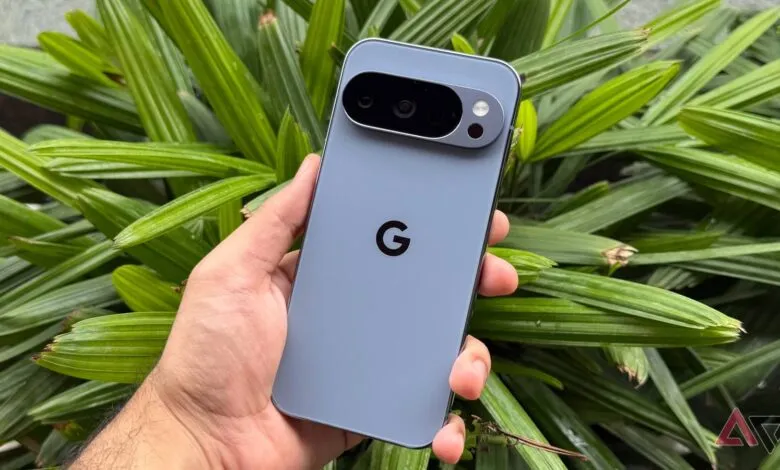 Hand holding a light blue Google Pixel 8 Pro smartphone with camera bar and Google logo.