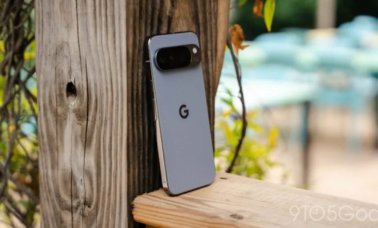 Google Pixel 8 Pro smartphone with a gray finish leaning against a wooden post.