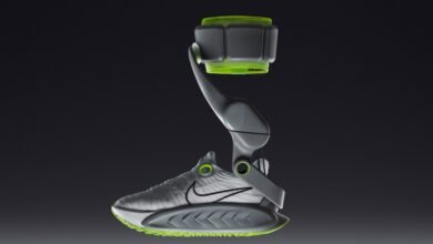 Futuristic athletic shoe with a gray exoskeleton and bright green accents.