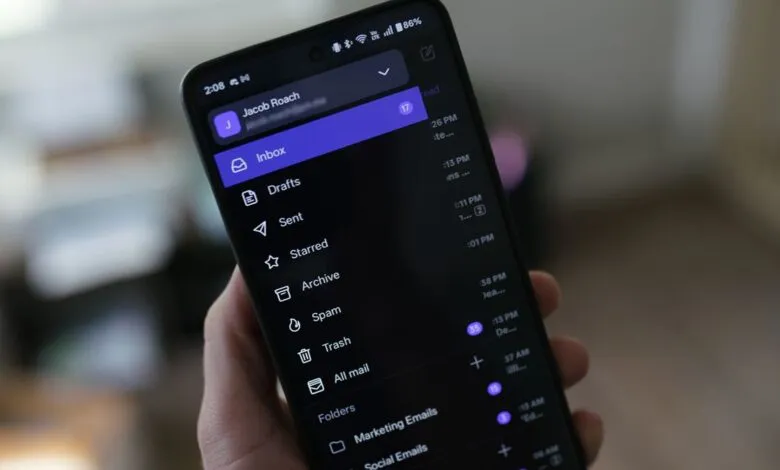 Smartphone displaying the Proton Mail app interface with inbox and folders.