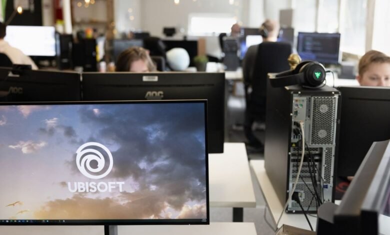 Ubisoft logo displayed on a computer monitor in a modern office setting.