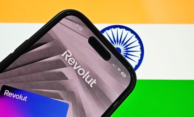 Smartphone displaying the Revolut app logo with the Indian flag in the background.