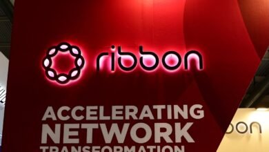 Ribbon Communications logo with illuminated text and slogan on a red display.