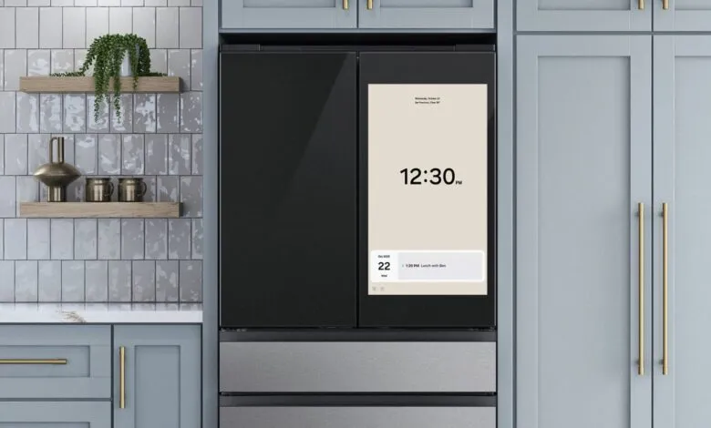 Smart refrigerator with a large touchscreen displaying the time and a calendar event.