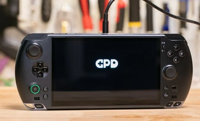 Close-up of a black GPD handheld gaming device with the GPD logo on its screen.