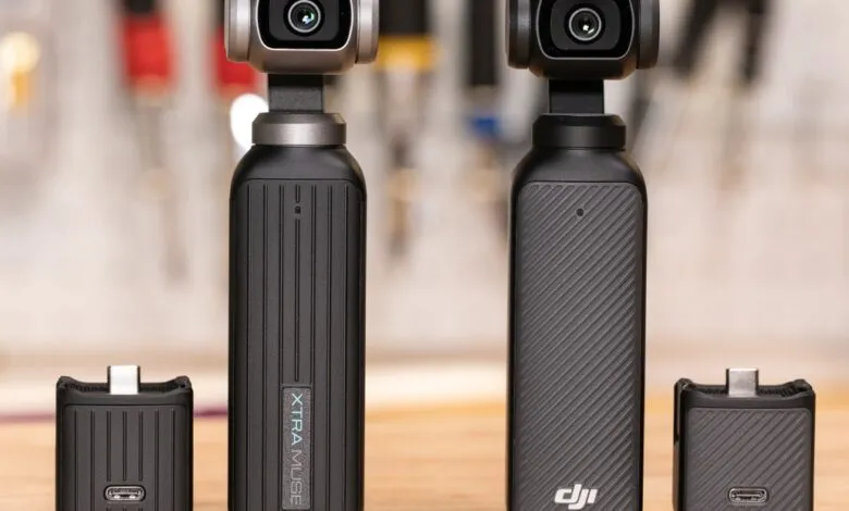 Two black DJI Osmo Action cameras with attached accessories on a wooden surface.
