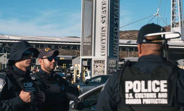 U.S. Customs and Border Protection officers stand guard at a border crossing.