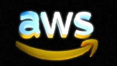 Close-up of the illuminated AWS logo with the Amazon smile arrow.