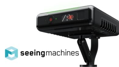 Black Seeing Machines driver monitoring system with a green light bar and eye icon.
