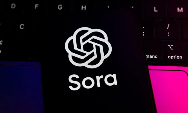 The OpenAI Sora logo and name displayed on a smartphone screen over a keyboard.