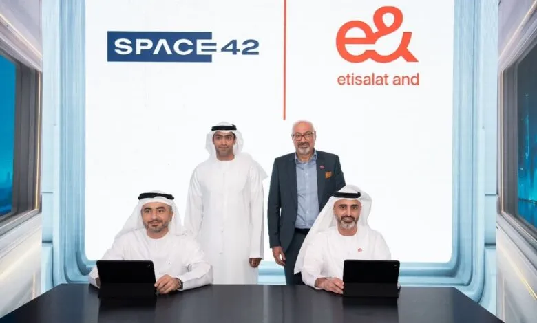 Four men in formal attire pose in front of logos for SPACE42 and etisalat.