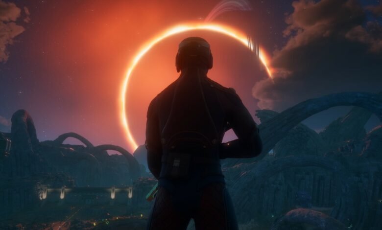 A person in a dark uniform stands looking at a vibrant solar eclipse over an alien landscape.