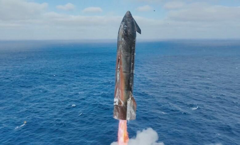 SpaceX Starship rocket ascending over the ocean with flames from its engines.