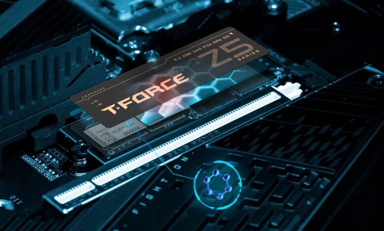 Close-up of a T-Force NVMe SSD installed on a computer motherboard with blue lighting.