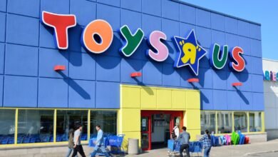 Exterior of a Toys R Us store with its iconic colorful logo and blue facade.