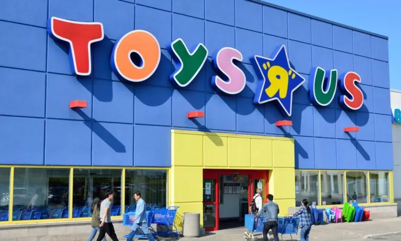 Exterior of a Toys R Us store with its iconic colorful logo and blue facade.