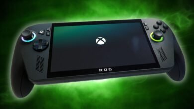 Close-up of a black handheld gaming device with an Xbox logo on the screen.