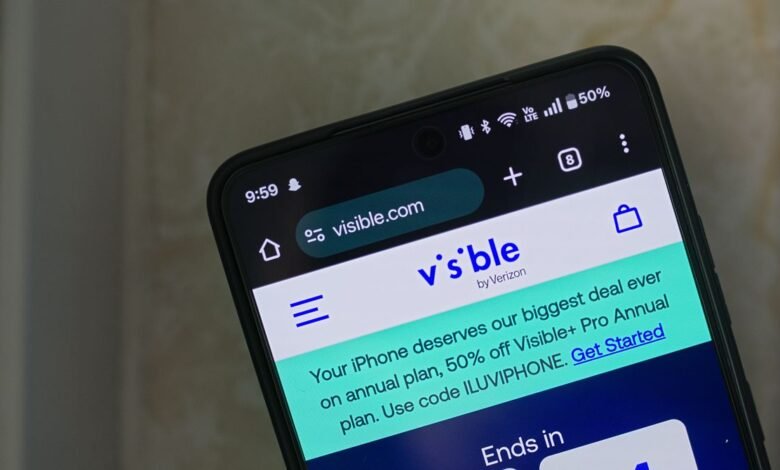 Close-up of a smartphone displaying the Visible wireless service website.